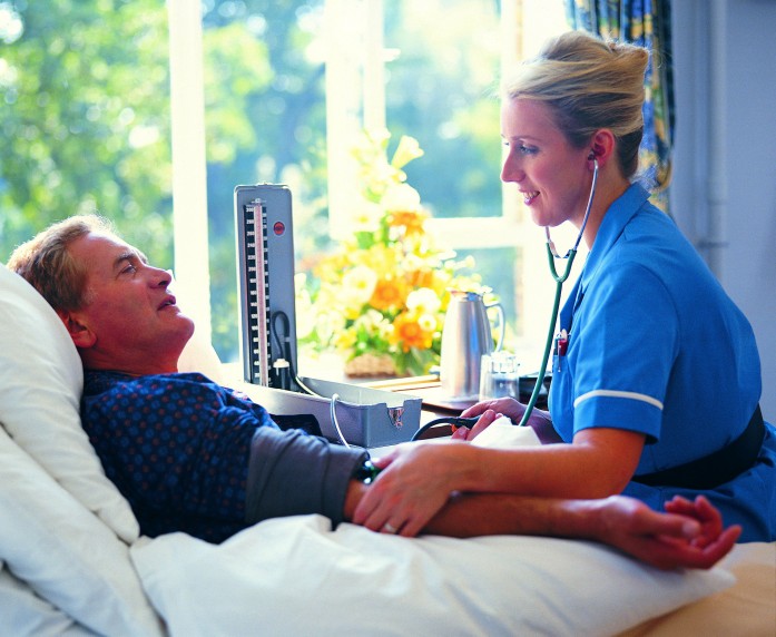 Nurse Taking Blood Pressure on Male Patient